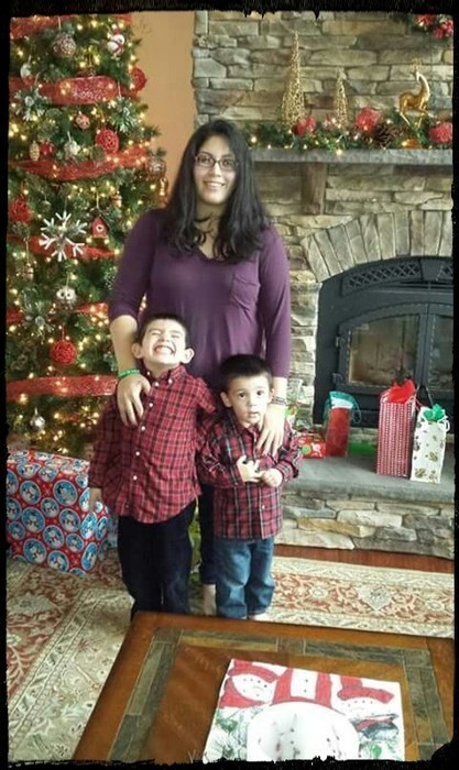 Mother with her two boys infront of christmas tree