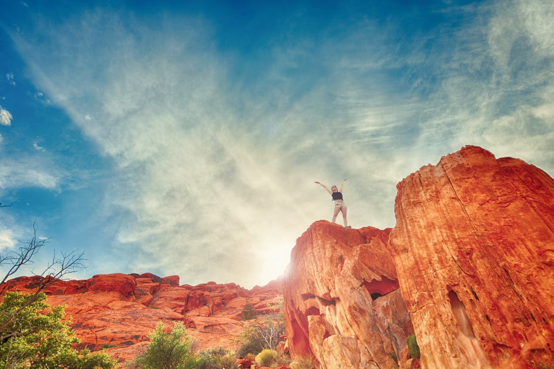 Person standing atop canyon